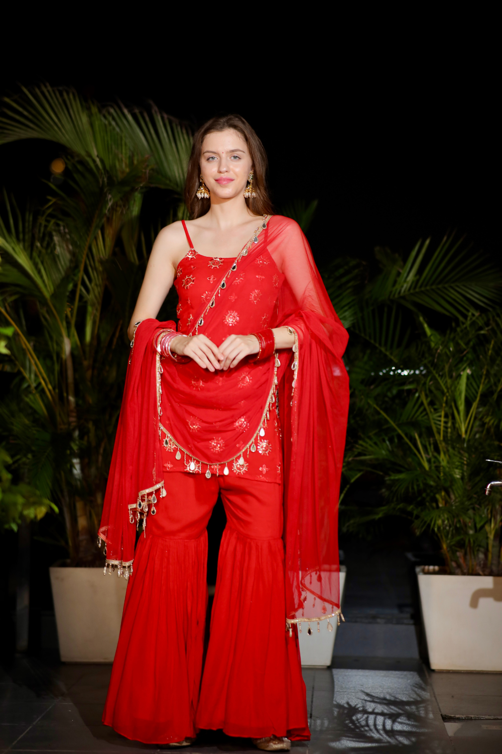 Red Rekha Sharara set by Imagine By Shiwali featuring a flowy sharara pants and matching top with intricate detailing.
