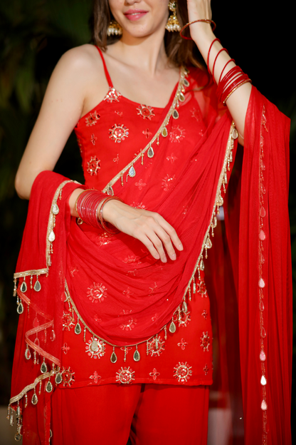Red Rekha Sharara set by Imagine By Shiwali featuring intricate embroidery and flowy fabric, perfect for festive occasions.