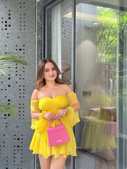 Yellow Rory dress by Imagine By Shiwali, featuring a stylish design and lightweight fabric, displayed on a hanger.