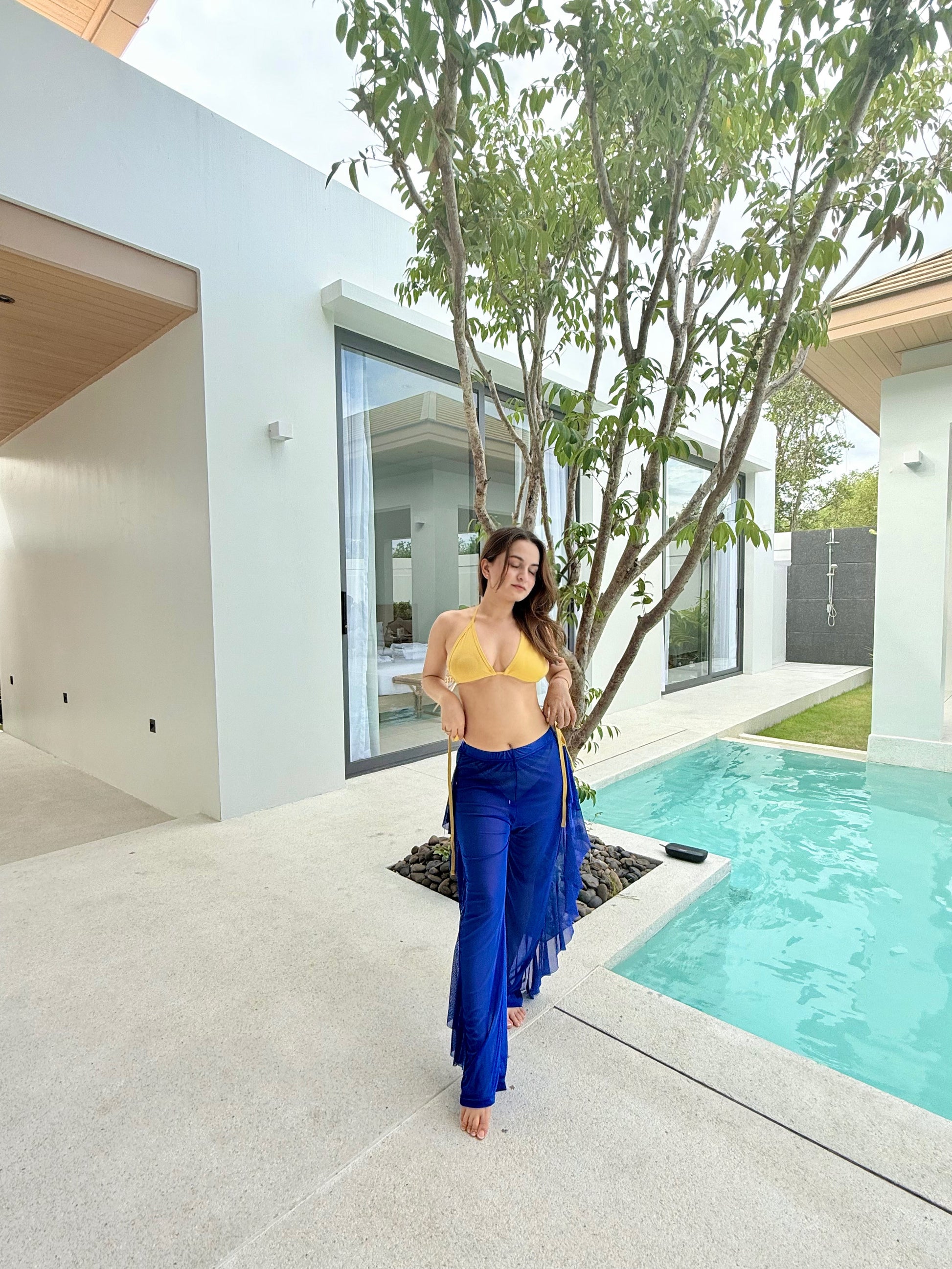 Sam yellow bikini top paired with navy blue pants from Imagine By Shiwali, shown on a model. Bright, stylish summer outfit.
