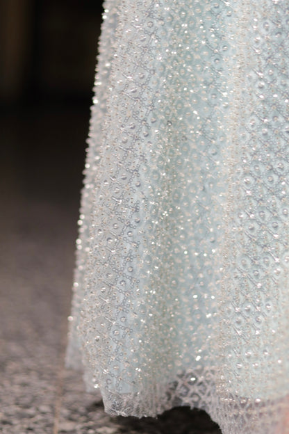 Ice blue Samantha gown by Imagine By Shiwali, featuring elegant fabric and intricate design, shown on a mannequin.