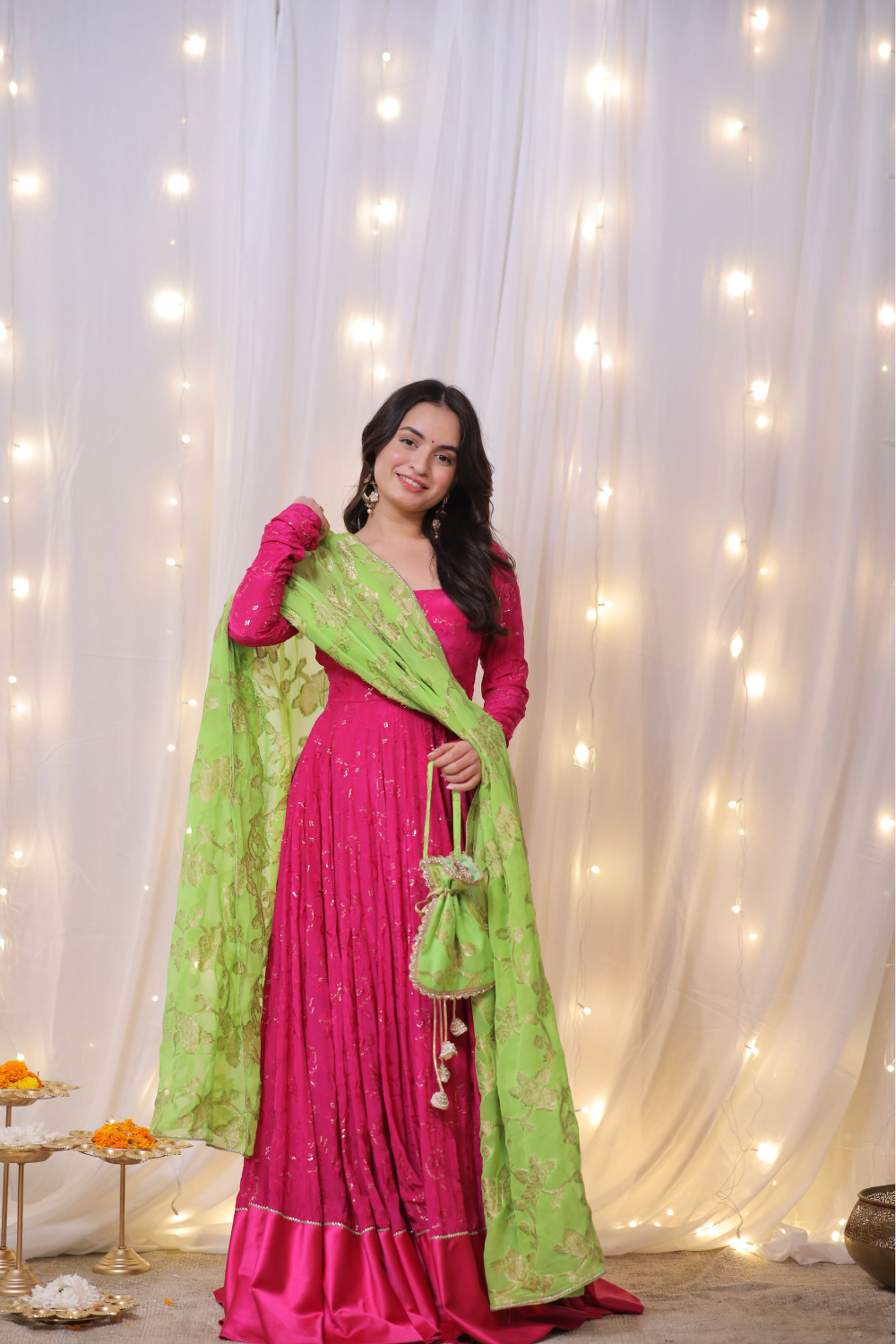 Fuchsia pink Sanvi Lehenga by Imagine with embroidered green dupatta and matching potli bag, traditional Indian bridal attire.