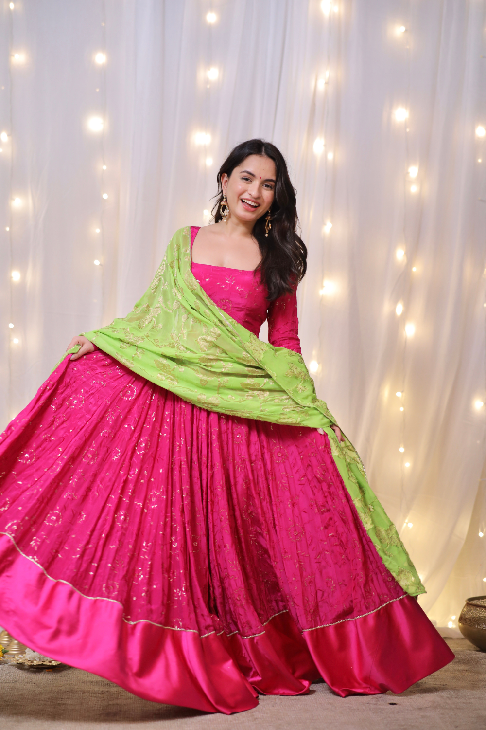 About Sanvi Fuchsia Pink Lehenga with Embroidered Green Dupatta and Potli Bag
