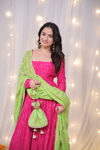 Fuchsia pink lehenga by Imagine with embroidered green dupatta and matching potli bag, shown on a model.