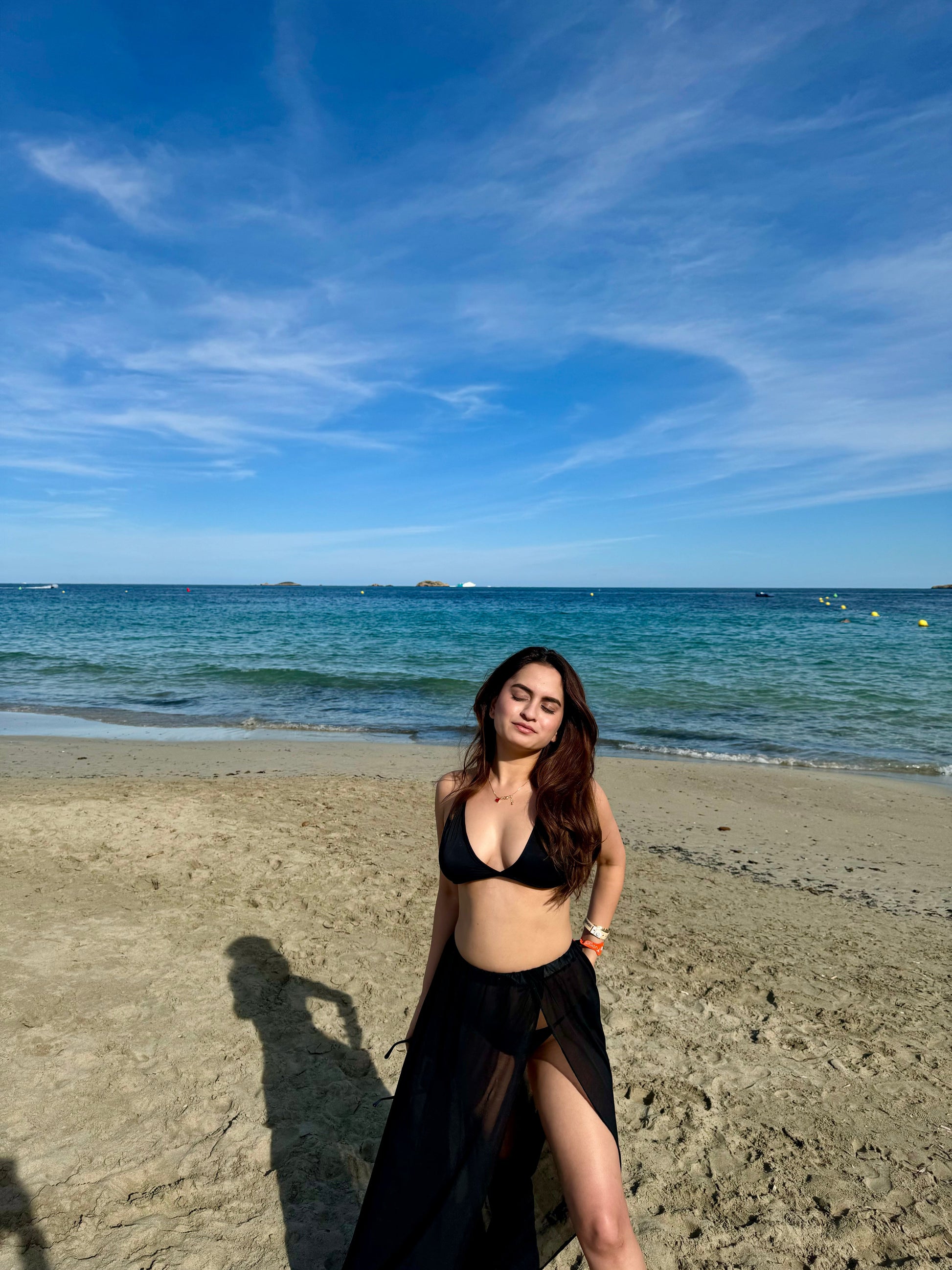 Scarlet black bikini set by Imagine By Shiwali featuring a triangle top and matching bottom on a plain background.