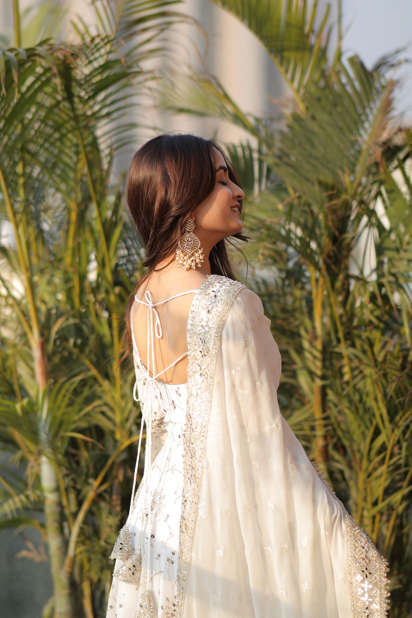 White embellished Maastani Anarkali dress by Imagine By Shiwali with intricate embroidery and flowing fabric.