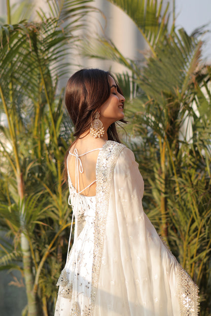White embellished Maastani Anarkali dress by Imagine By Shiwali with intricate embroidery and flowing fabric.