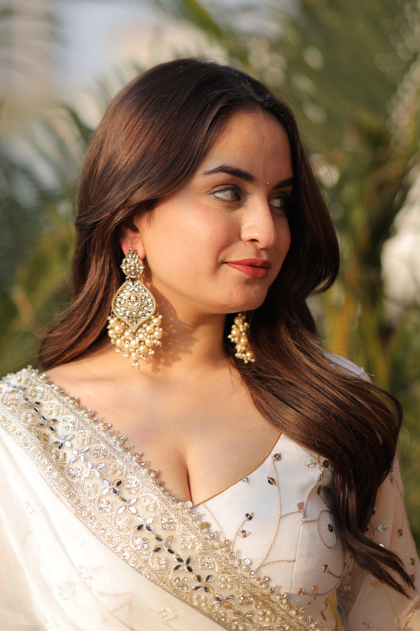 White embellished Maastani Anarkali dress by Imagine By Shiwali with intricate embroidery and flowing fabric, detailed view of the design.