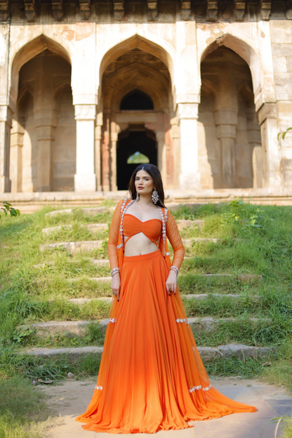 Vridhi Sunset Radiance orange lehenga set with embroidered cape by Imagine By Shiwali, featuring vibrant fabric and intricate embroidery.