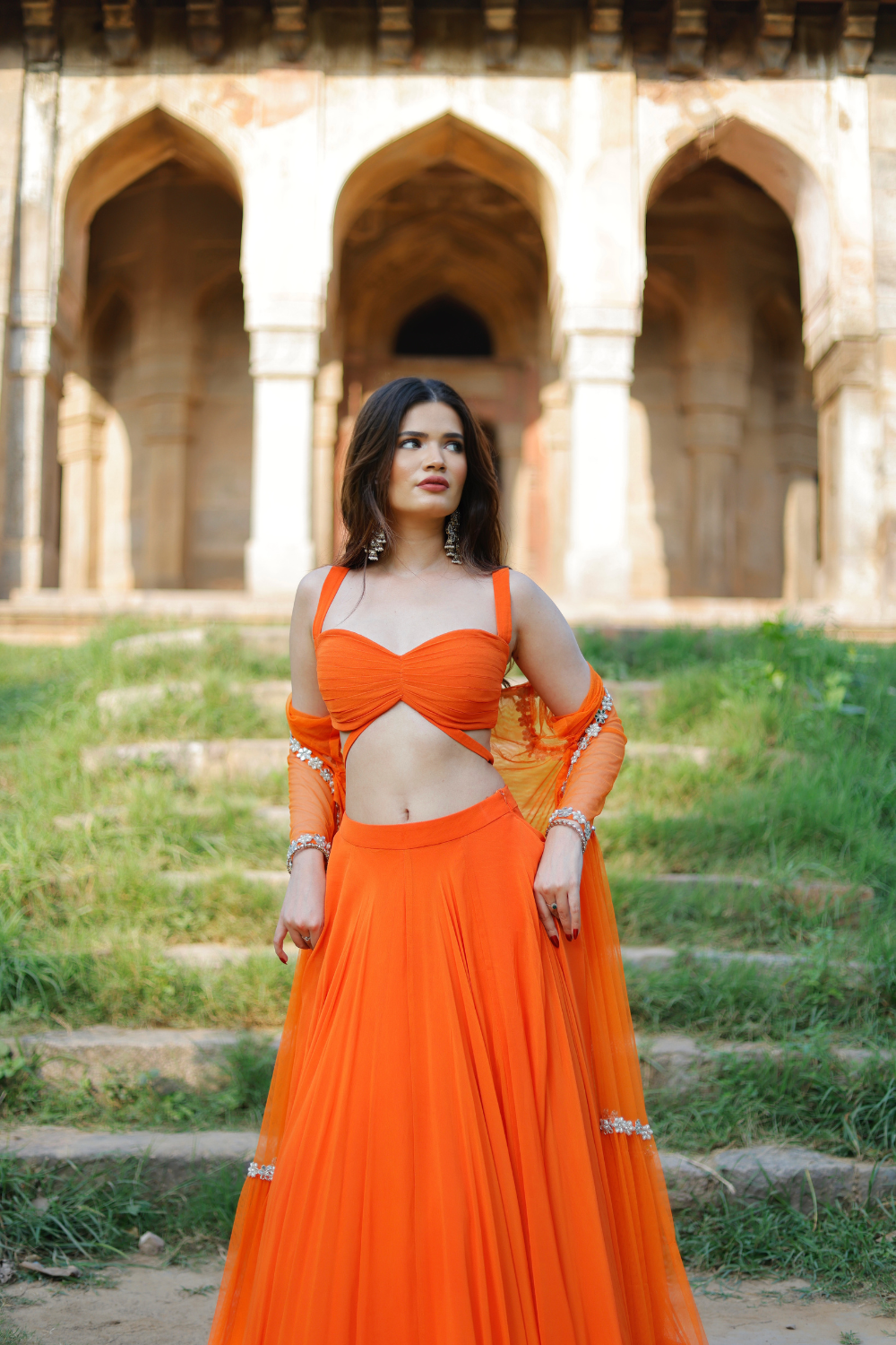 Orange Vridhi Sunset Radiance Lehenga Set by Imagine By Shiwali with an embroidered cape, showcasing intricate embroidery and vibrant design.
