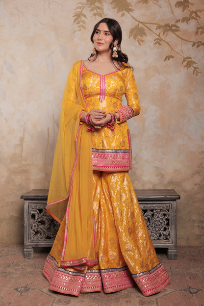 Yellow and pink Abhilasha sharara suit by Imagine By Shiwali featuring intricate embroidery and traditional styling.