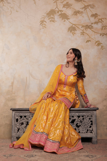 Yellow and pink Abhilasha sharara suit by Imagine By Shiwali, featuring traditional embroidery and flowing fabric.