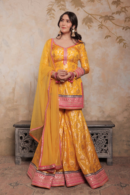 Yellow and pink Abhilasha sharara suit by Imagine By Shiwali, featuring traditional embroidery and vibrant fabric.
