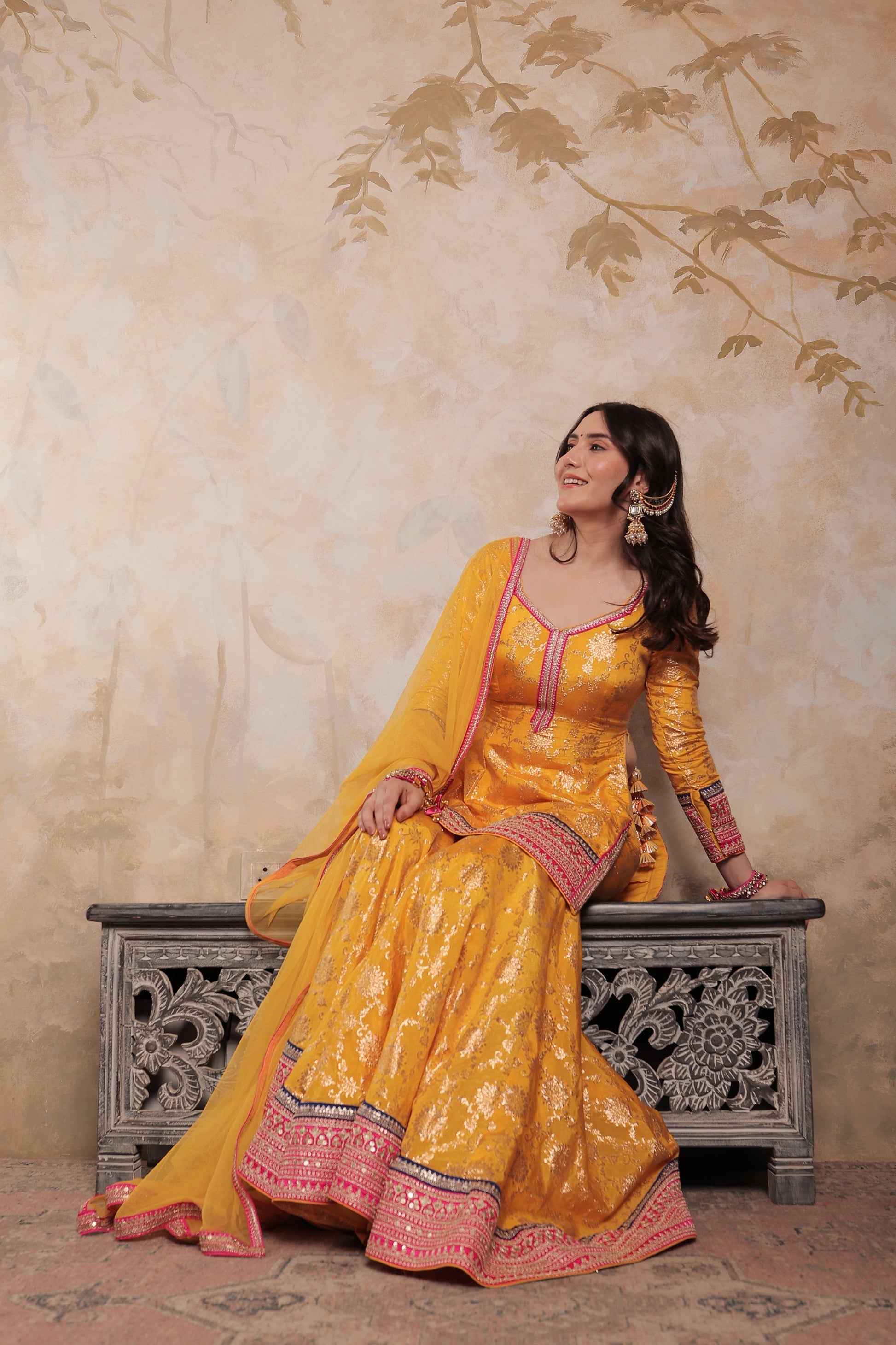 Yellow and pink Abhilasha sharara suit by Imagine By Shiwali, featuring vibrant traditional Indian attire with intricate detailing.