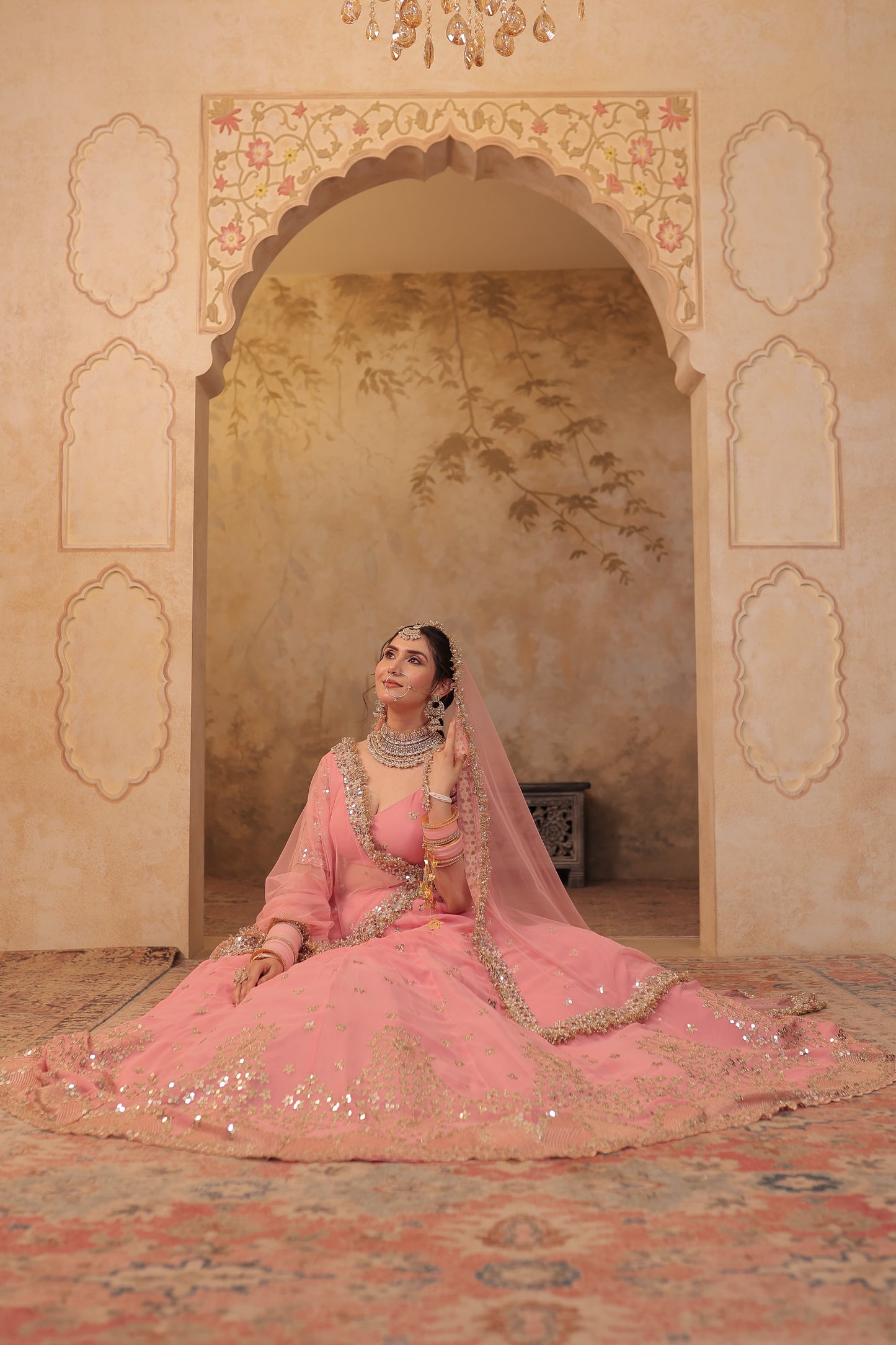 Soft pink bridal lehnga by Imagine By Shiwali with intricate embroidery and flowing fabric, perfect for wedding celebrations.