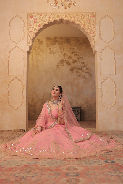 Soft pink bridal lehnga by Imagine By Shiwali with intricate embroidery and flowing fabric, perfect for wedding celebrations.
