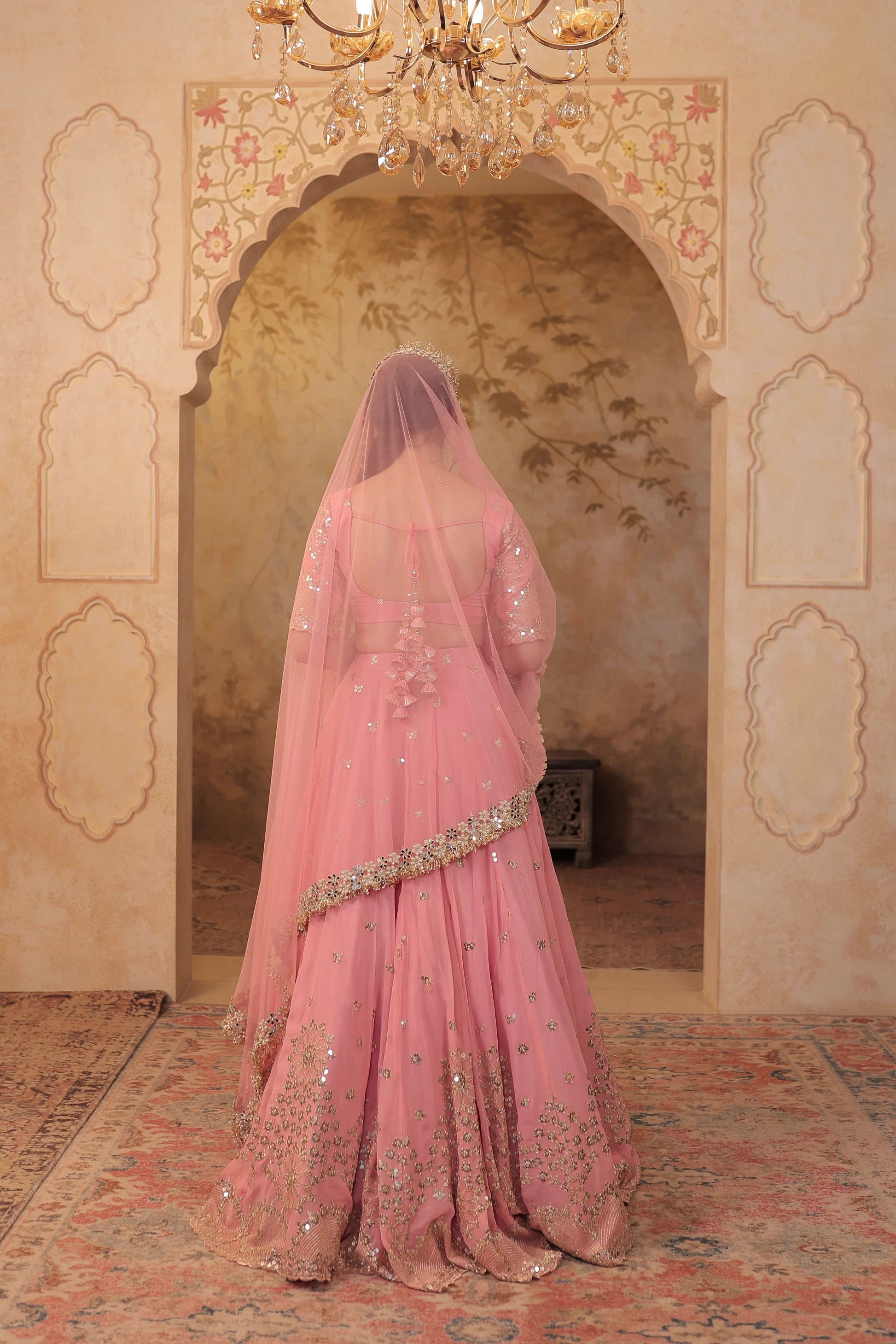 Soft pink bridal lehnga by Imagine by Shiwali featuring intricate embroidery and flowing fabric, perfect for special occasions.