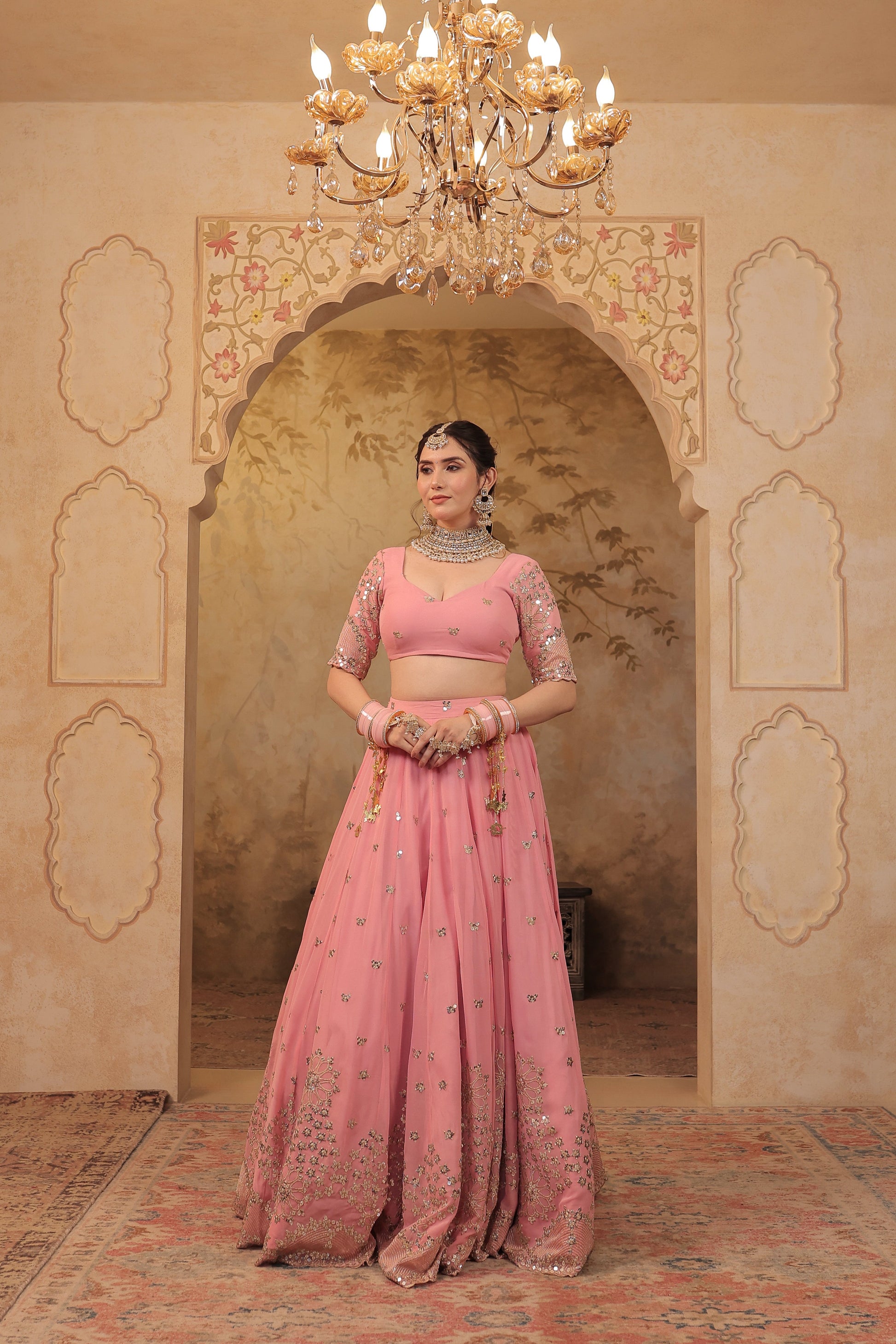Soft pink bridal lehnga by Imagine, featuring intricate embroidery and flowing fabric, perfect for a traditional wedding look.