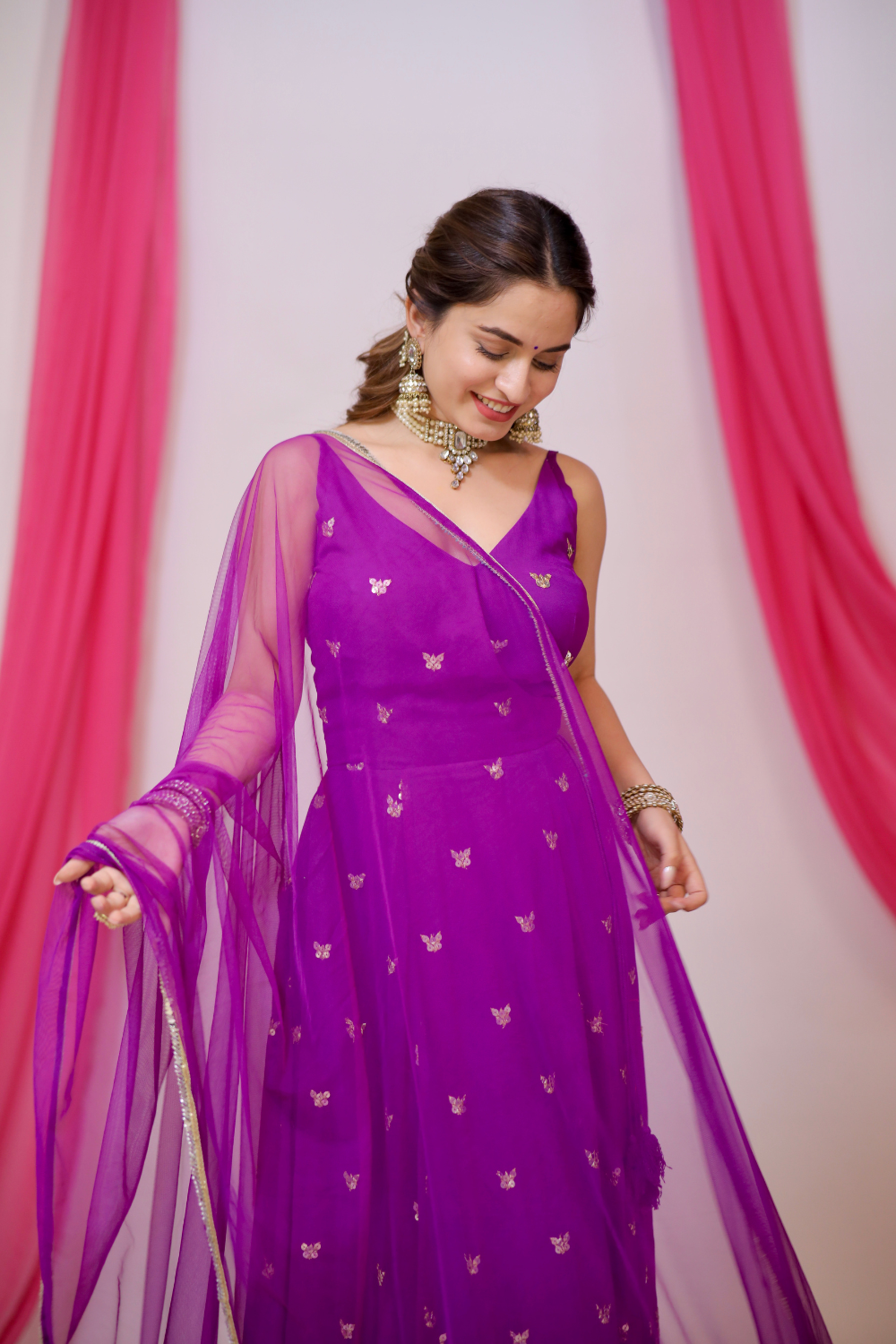 A violet Angrakha style Anarkali dress by Imagine By Shiwali, featuring intricate embroidery and flowing fabric.