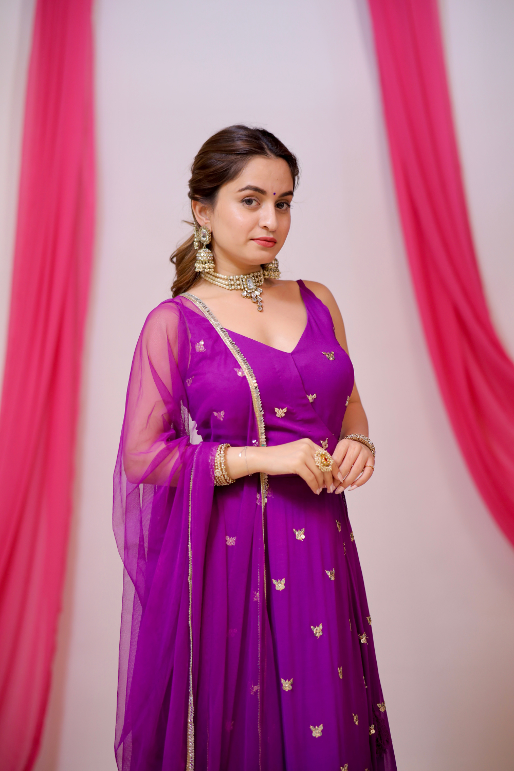 A violet Angrakha style Anarkali suit by Imagine By Shiwali, featuring intricate embroidery and flowy fabric.
