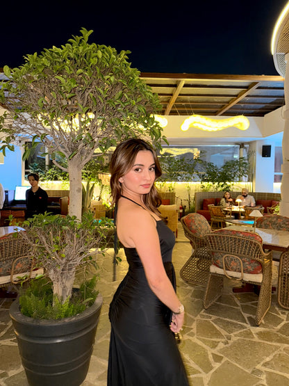 Black midi dress by Imagine By Shiwali, flowing fabric, sleeveless design, and fitted waist, perfect for elegant occasions.