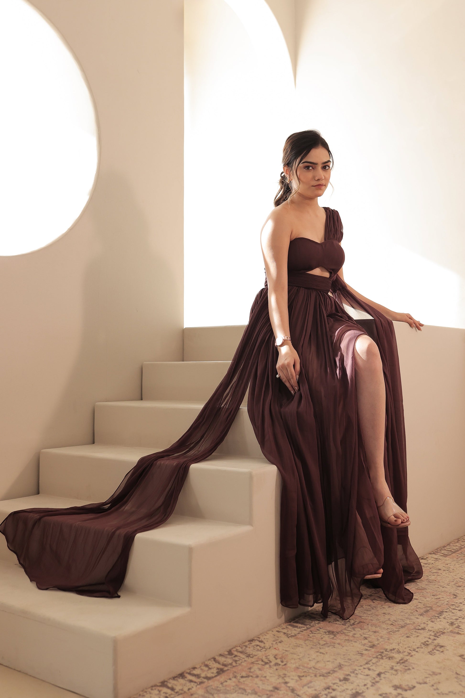 Imagine By Shiwali Britney brown gown shown with flowing fabric and elegant design on a model.