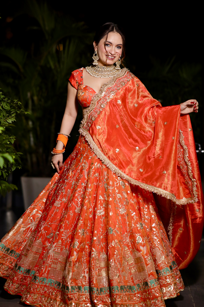 Chandani orange lehenga with intricate zari work by Imagine by Shiwali, showcasing detailed embroidery and traditional design.