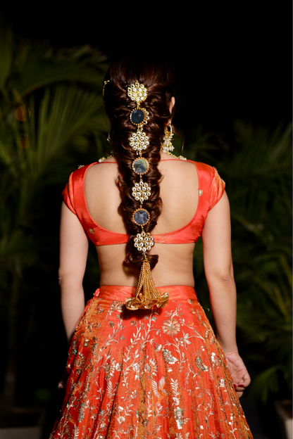 Chandani orange lehnga with intricate zari work from Imagine By Shiwali, featuring detailed embroidery and traditional design.
