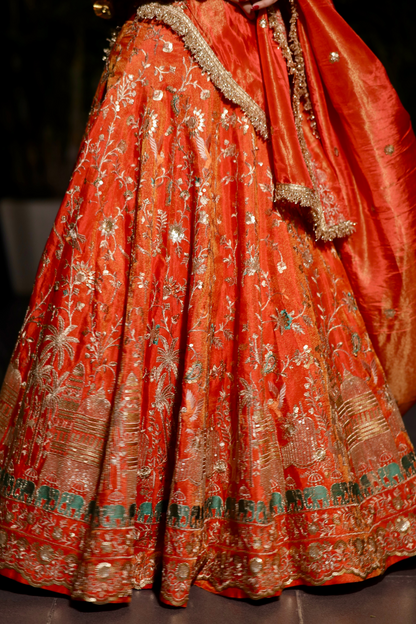 Chandani orange lehenga with intricate zari work by Imagine By Shiwali, featuring traditional embroidery and vibrant fabric.