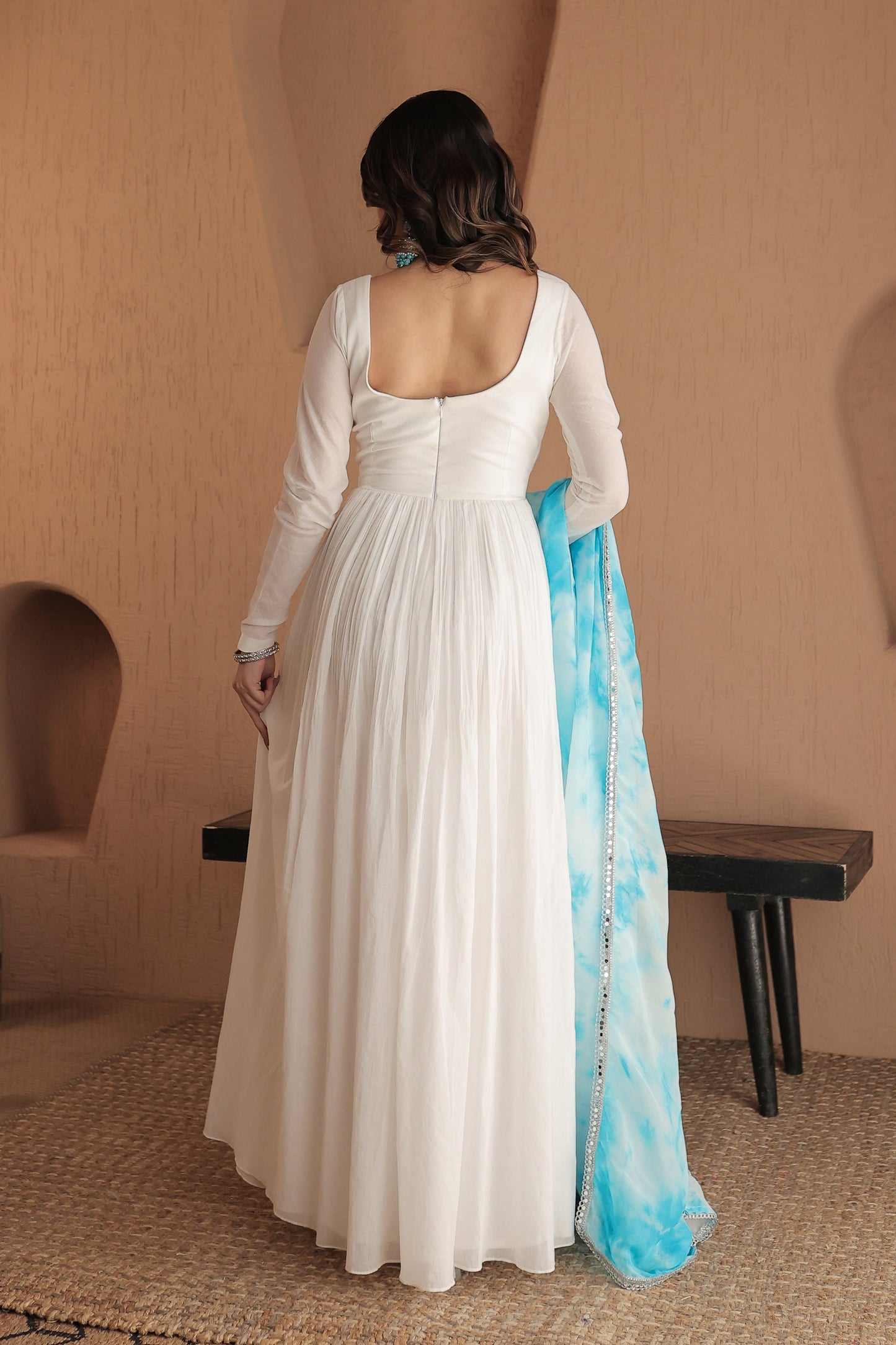 White Chandani mulmul Anarkali dress by Imagine By Shiwali with intricate embroidery and flowing fabric.