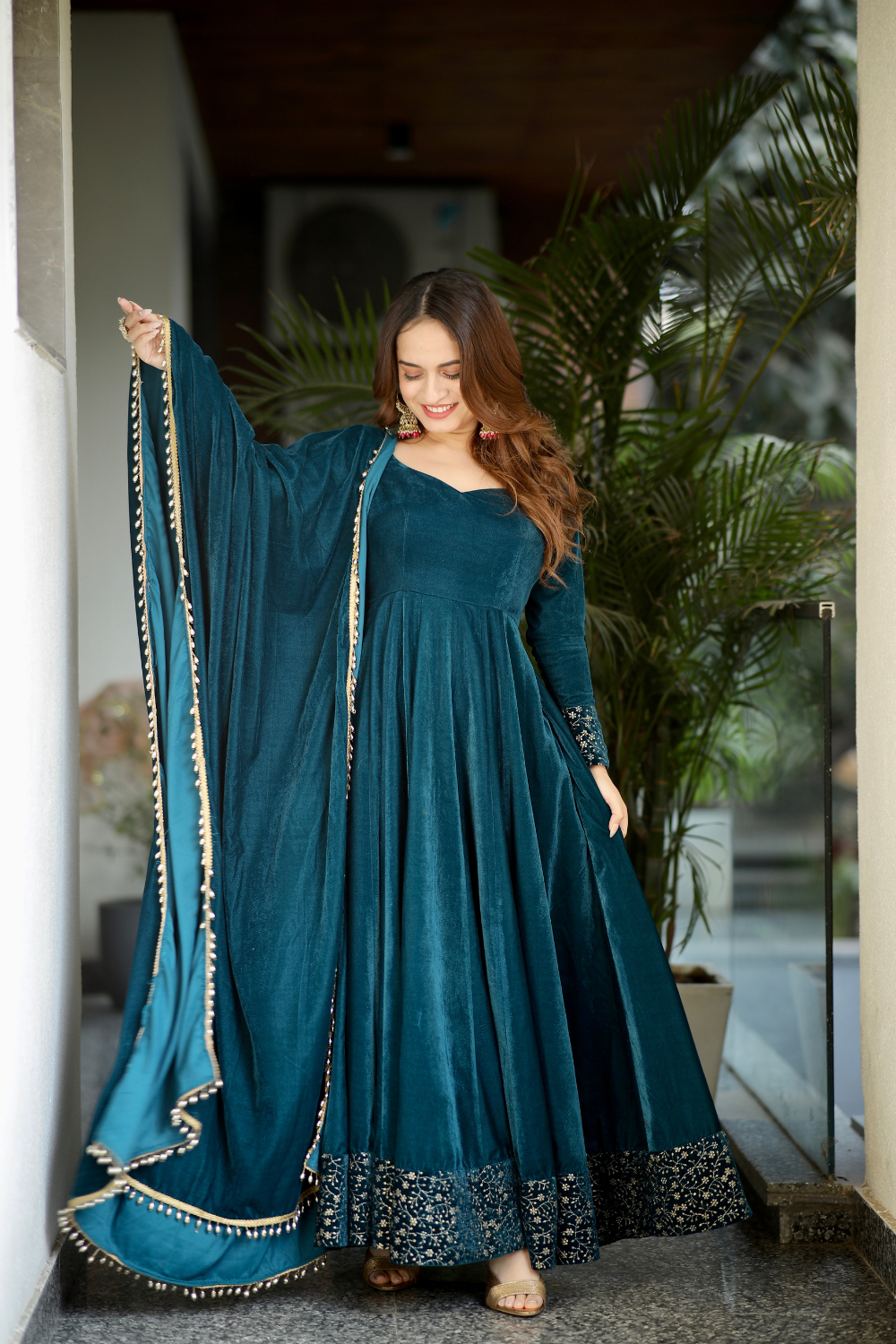 Sea green Deepika Velvet Anarkali dress by Imagine By Shiwali featuring intricate embroidery and flowing fabric.