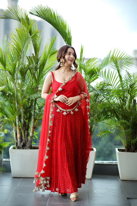Imagine by Shiwali Dolly Red Anarkali dress featuring intricate embroidery and flowing fabric in vibrant red.
