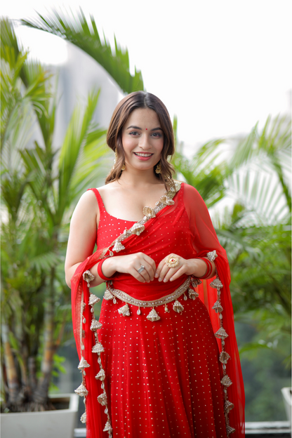 Red Dolly Anarkali dress by Imagine By Shiwali featuring intricate embroidery and flowing fabric.