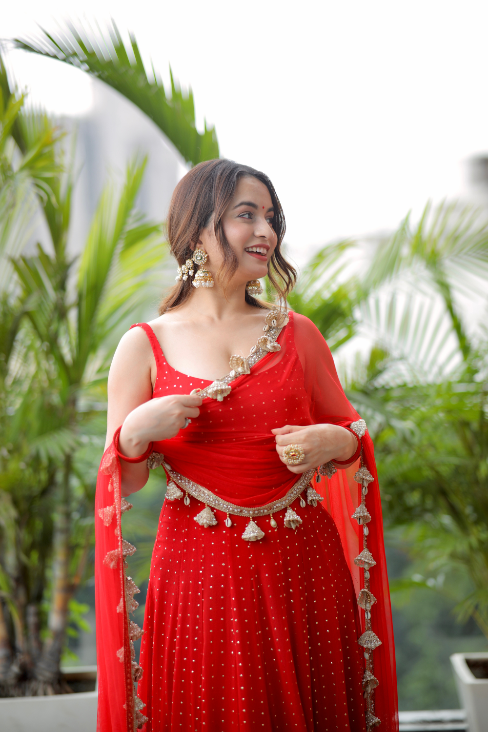 Red Dolly Anarkali dress by Imagine By Shiwali featuring intricate embroidery and flowing fabric, perfect for traditional occasions.