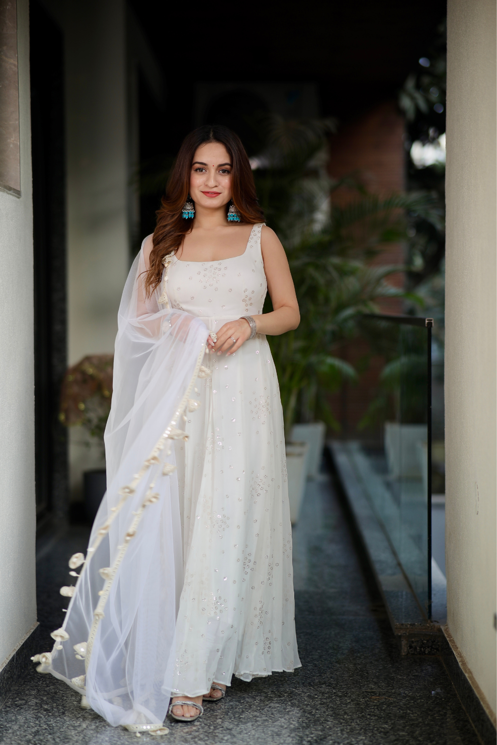 White Dolly Anarkali dress by Imagine By Shiwali with intricate embroidery and flowing fabric, perfect for festive occasions.
