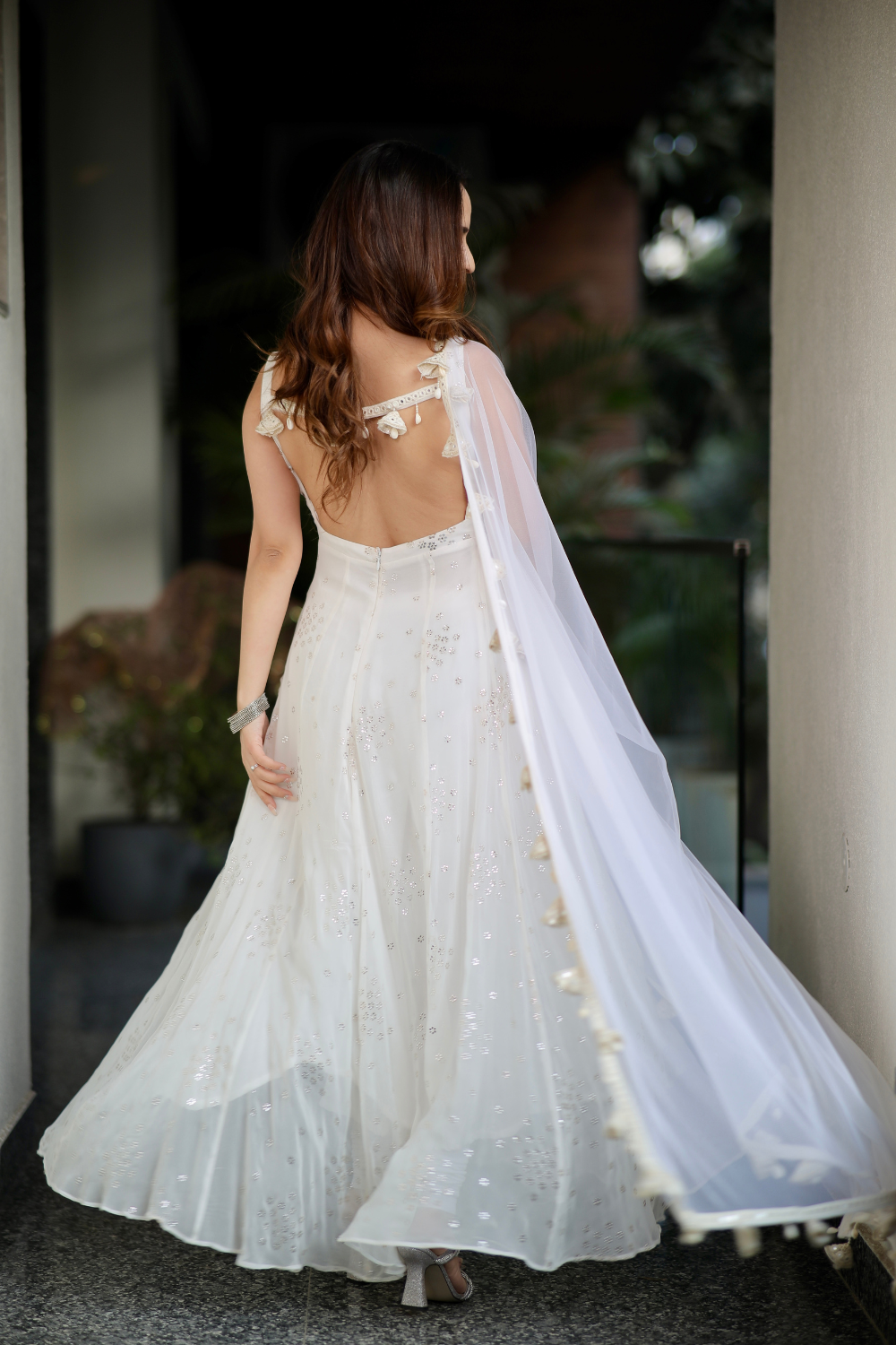 White Dolly Anarkali dress by Imagine by Shiwali featuring intricate embroidery and flowing fabric.