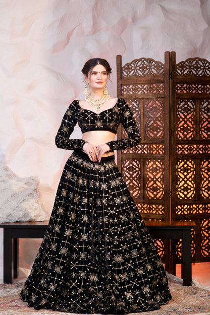 Black velvet lehnga by Imagine By Shiwali featuring intricate embroidery and traditional design for elegant Indian attire.