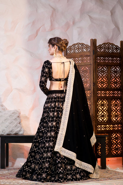 Black velvet lehnga from Geetanjali collection by Imagine By Shiwali, showcasing intricate fabric and elegant traditional design.