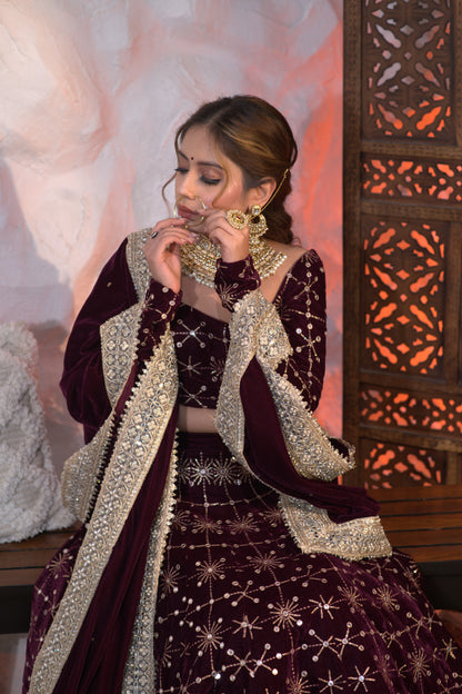 Elegant wine-colored velvet lehnga by Imagine By Shiwali featuring intricate embroidery and traditional design.