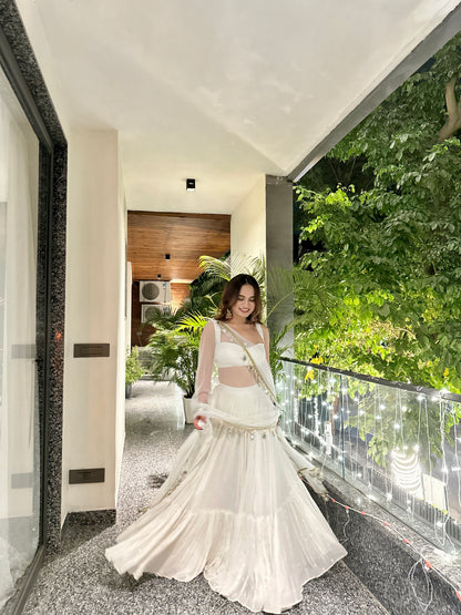Elegant white Hans Lehnga by Imagine by Shiwali featuring intricate embroidery and traditional design.