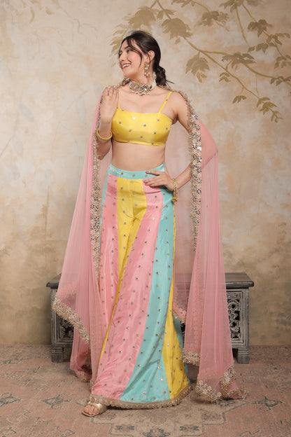 Multicolour Kalki sharara set by Imagine By Shiwali, featuring vibrant fabric and traditional embroidery, displayed on a hanger.