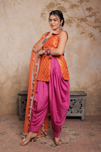 Orange and purple Kavya dhoti set by Imagine By Shiwali, featuring traditional Indian attire with intricate designs.