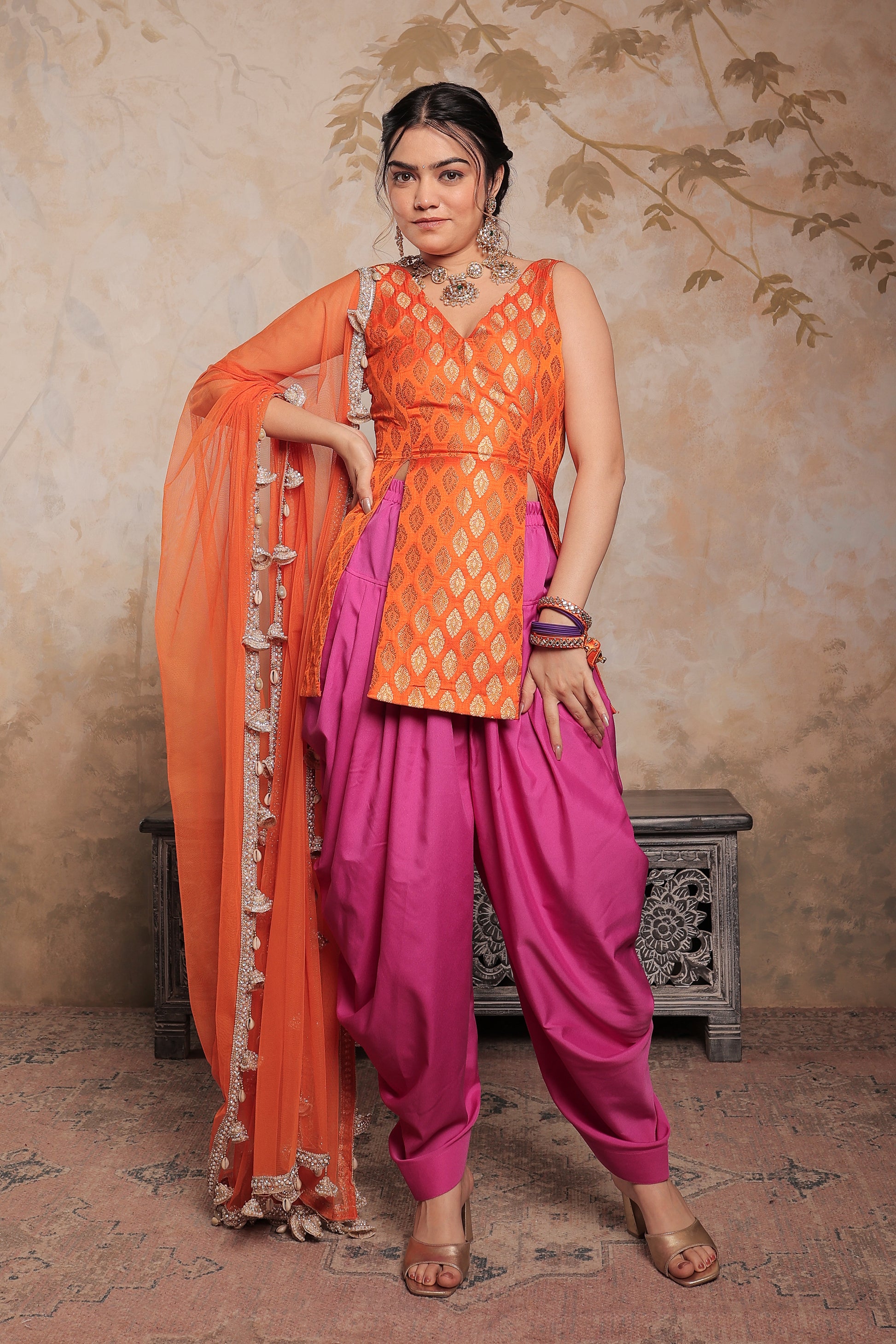 Orange and purple Kavya dhoti set by Imagine By Shiwali, featuring traditional Indian attire with intricate design.