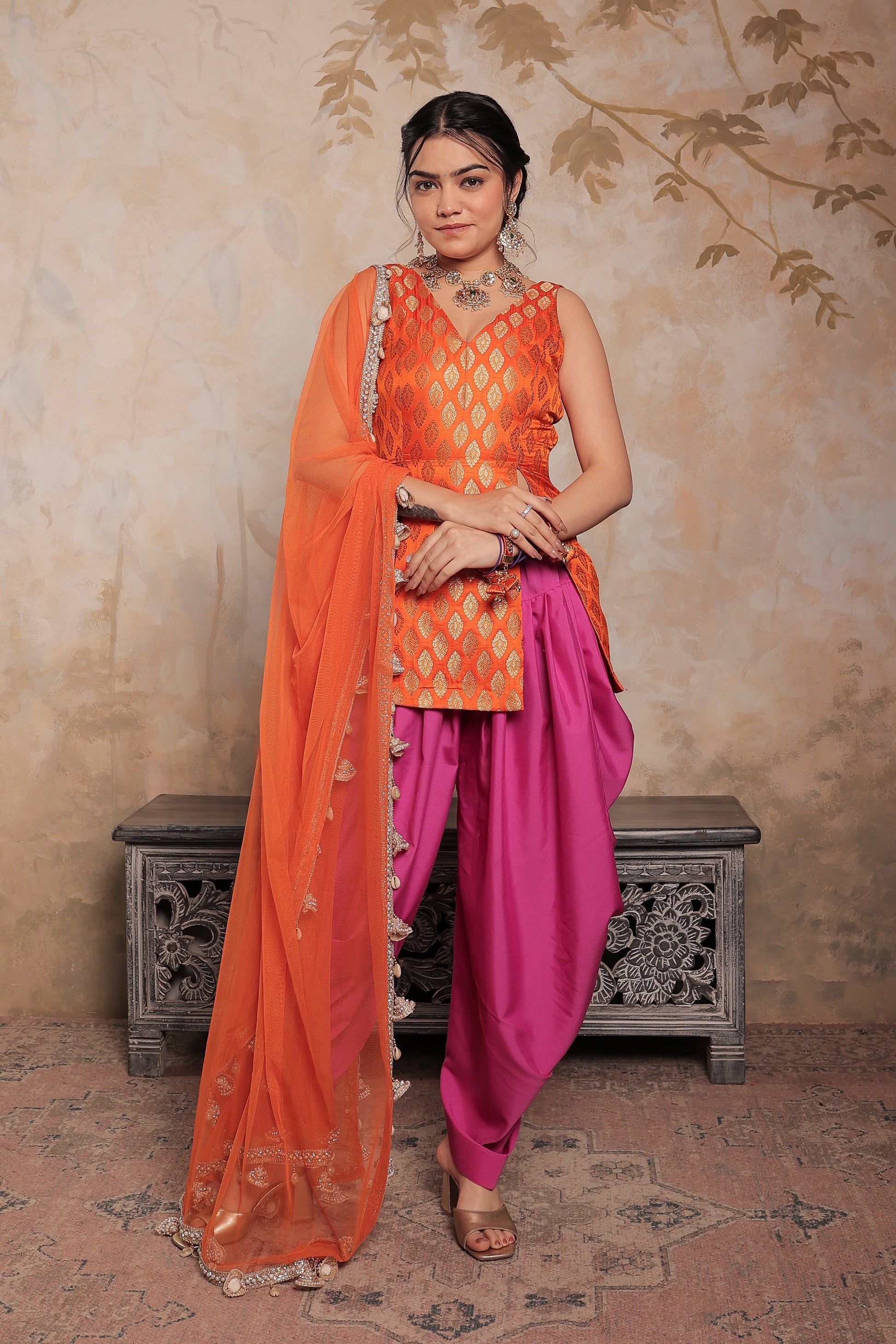 Kavya dhoti set in orange and purple by Imagine By Shiwali, featuring traditional Indian attire with vibrant colors and intricate design.