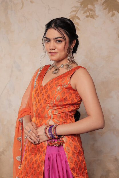 Orange and purple Kavya dhoti set by Imagine By Shiwali, featuring traditional fabric and intricate design details.