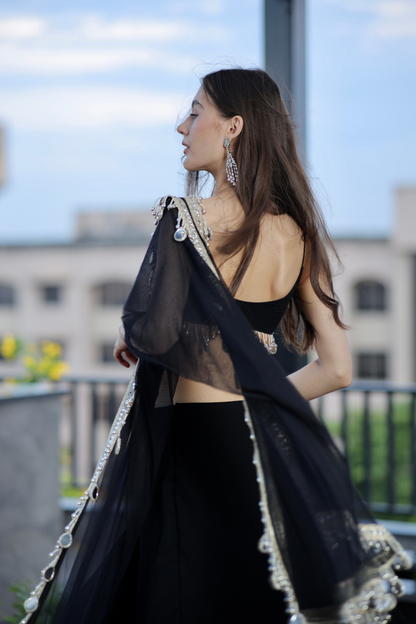 Black Kiara Lehnga by Imagine By Shiwali featuring intricate embroidery and flowing fabric, worn for traditional celebrations.
