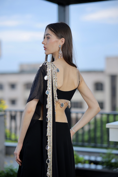 Black Kiara Lehnga by Imagine By Shiwali featuring intricate embroidery and traditional design on flowing fabric.