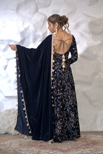 Navy blue velvet Malaika Anarkali dress by Imagine By Shiwali with intricate embroidery and a flowing silhouette.