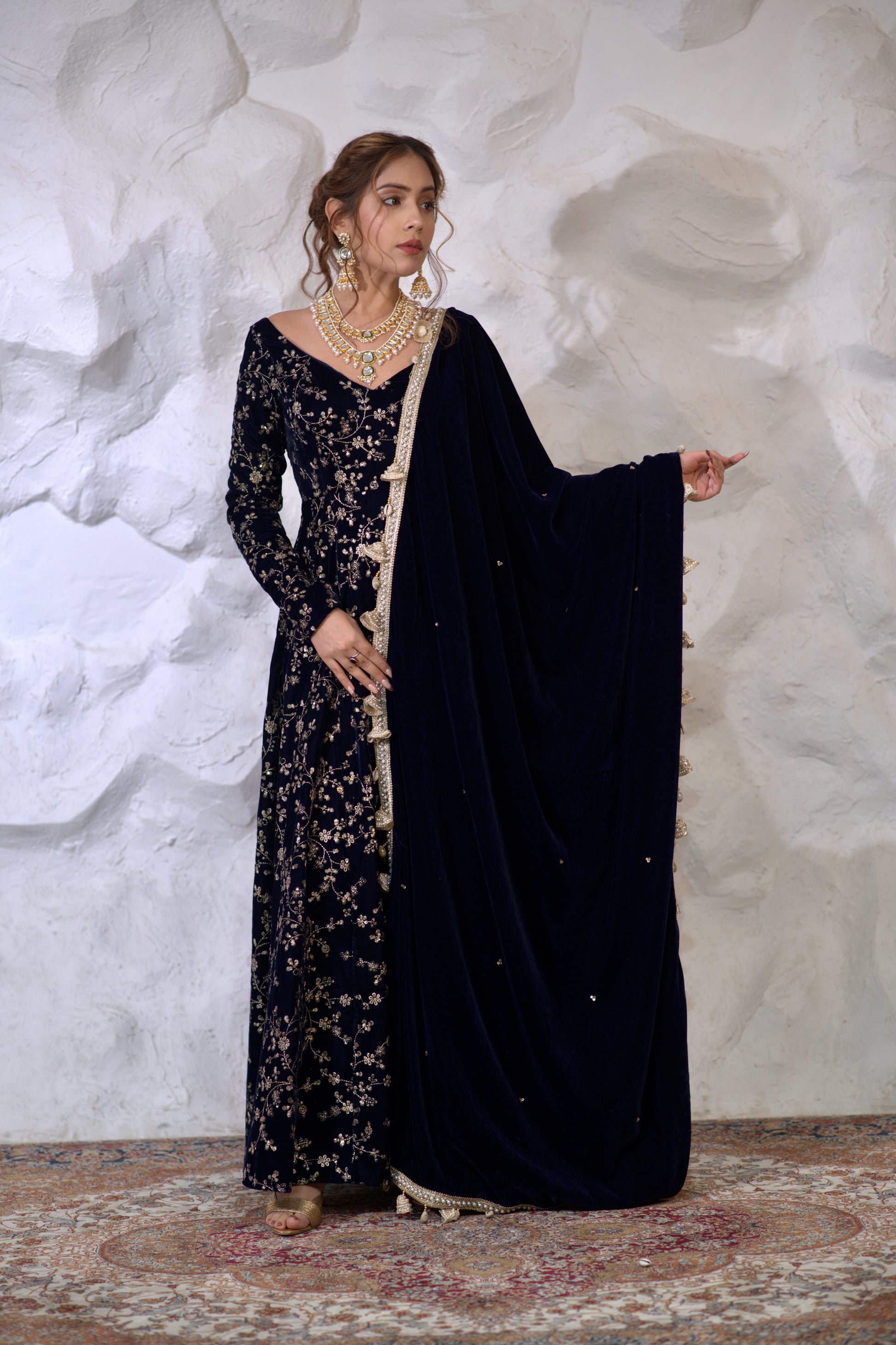 Navy blue velvet Anarkali dress by Imagine By Shiwali with intricate design and flowing fabric, styled for traditional occasions.