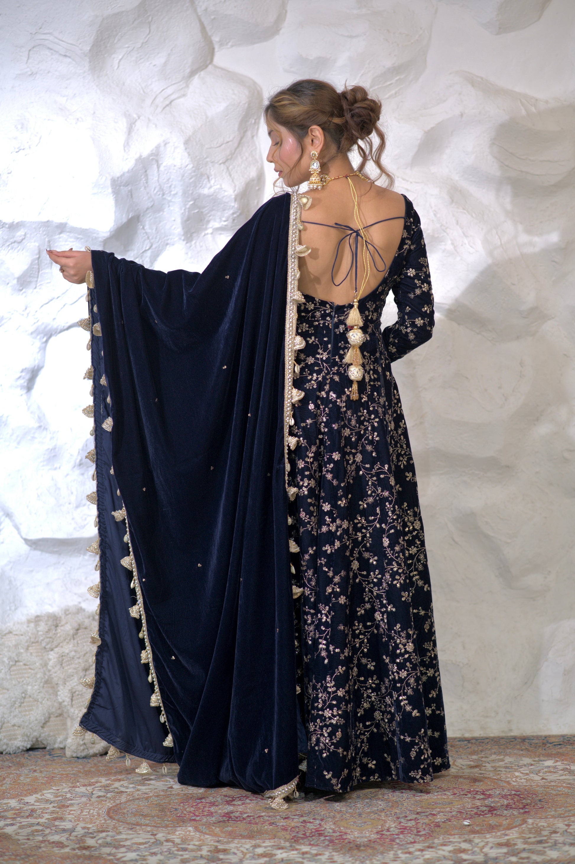 Navy blue Malaika Velvet Anarkali dress by Imagine By Shiwali, featuring intricate embroidery and flowing fabric.